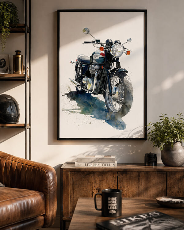 A framed watercolor-style motorcycle print hangs on a beige wall in a styled living room with a brown leather sofa, wooden console, shelf, and plants.