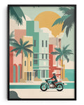 A framed art print featuring a retro-style vector illustration of a person riding a motorcycle along a tropical beach street with palm trees and colorful buildings under a large sun.
